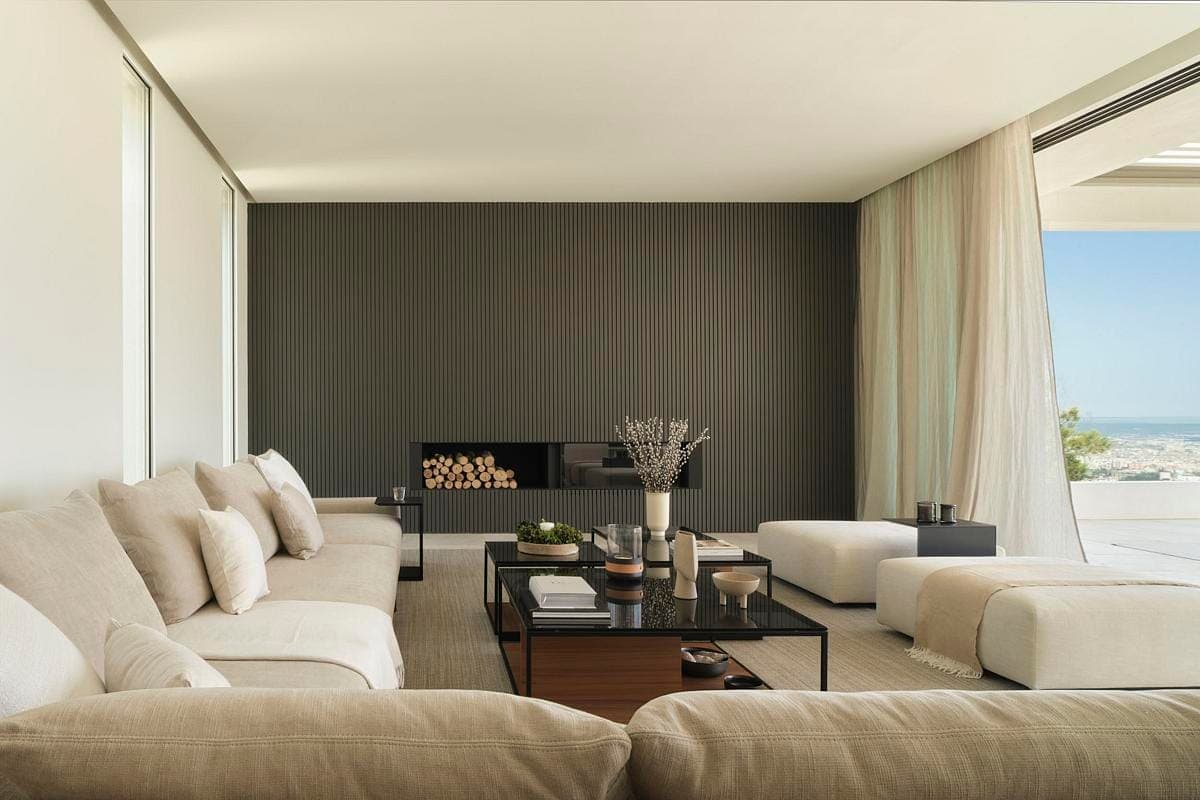 Sophisticated modern living room with natural light and comfortable furnishings for stylish relaxation.