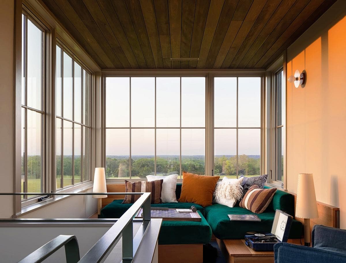 Bright and inviting sitting area with nature views and stylish, comfortable furnishings.