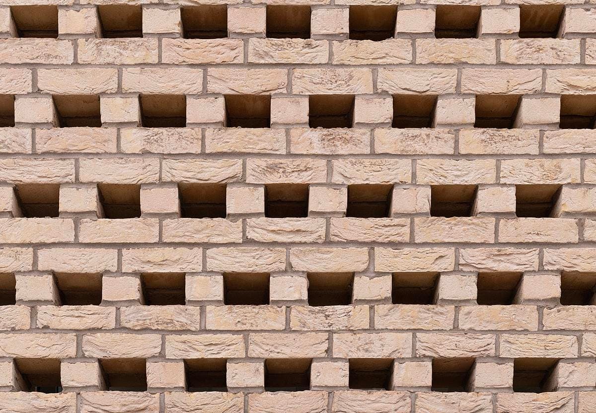Elegant brick wall with unique horizontal openings, enhancing texture and contemporary design.