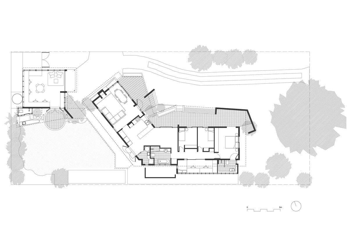 Modern residential floor plan with landscaped garden, open living areas, and private quarters.