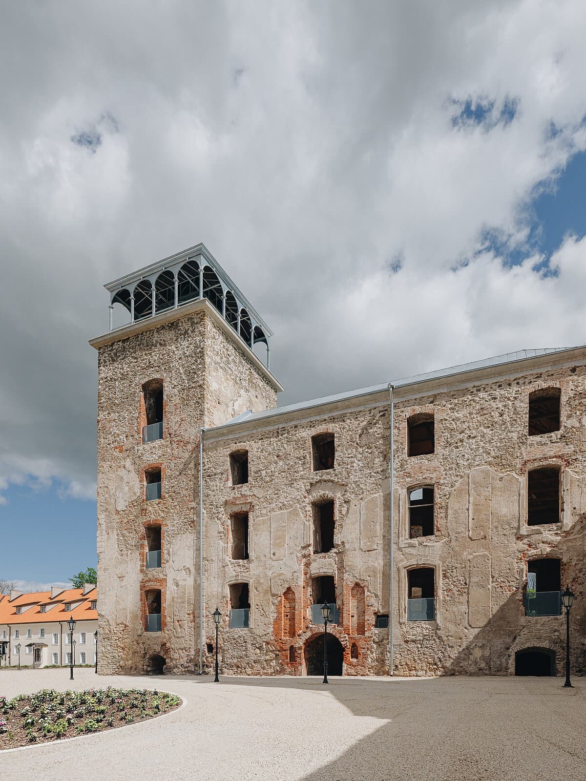 Charming historic stone building with a gravel courtyard and inviting atmosphere.