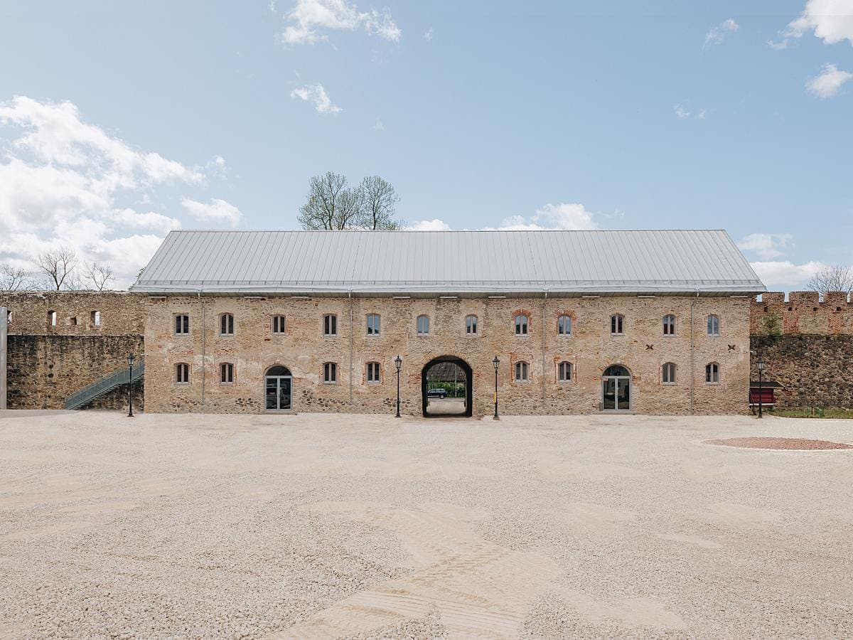 Elegant historic stone building with modern features set in a tranquil courtyard.