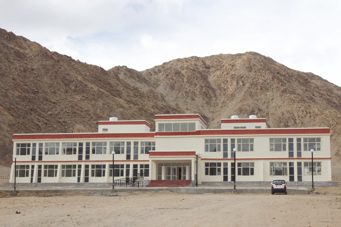 Modern two-story building in arid mountains, Leh Satellite Campus Kashmir University.