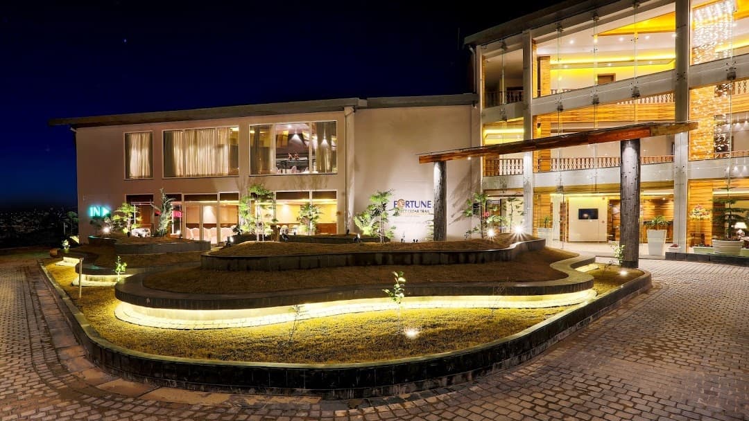 Luxurious ITC Welcome Hotel night view with fountain and elegant architecture.
