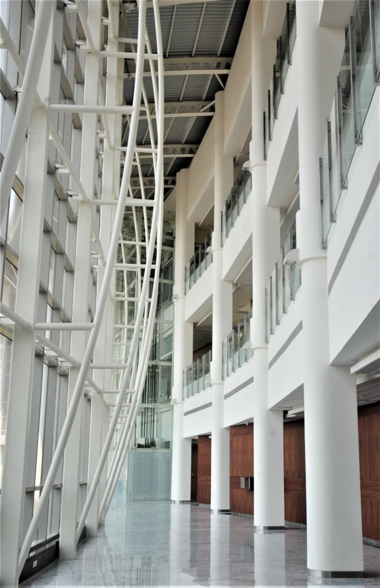 Modern interior of Reliance Technology Group Research Facility with large windows and steel beams.