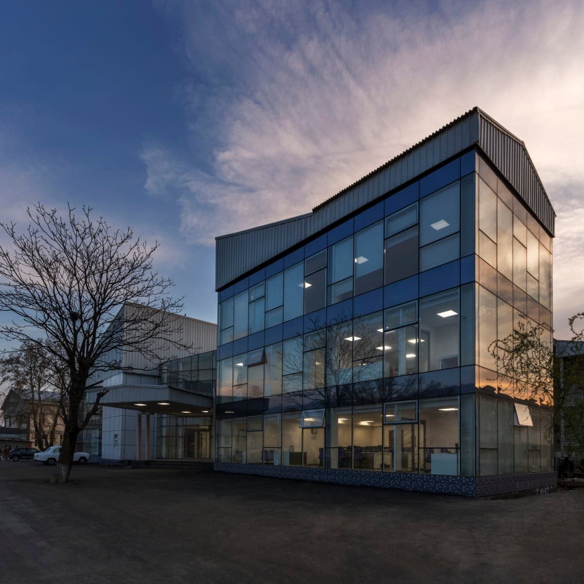 Kashmir University Administration Building at dusk, reflecting the evening sky.