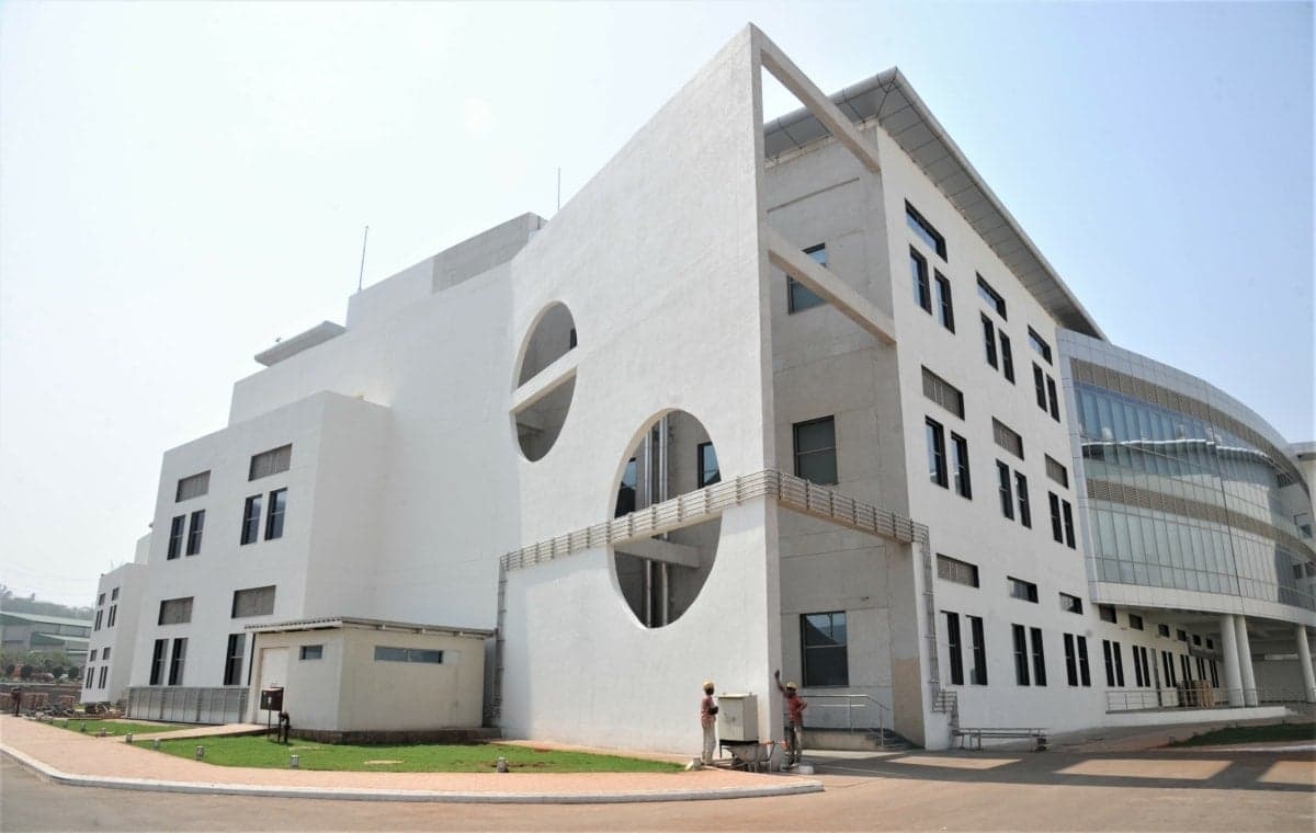 Reliance Technology Group Research Facility with modern white facade and geometric design.