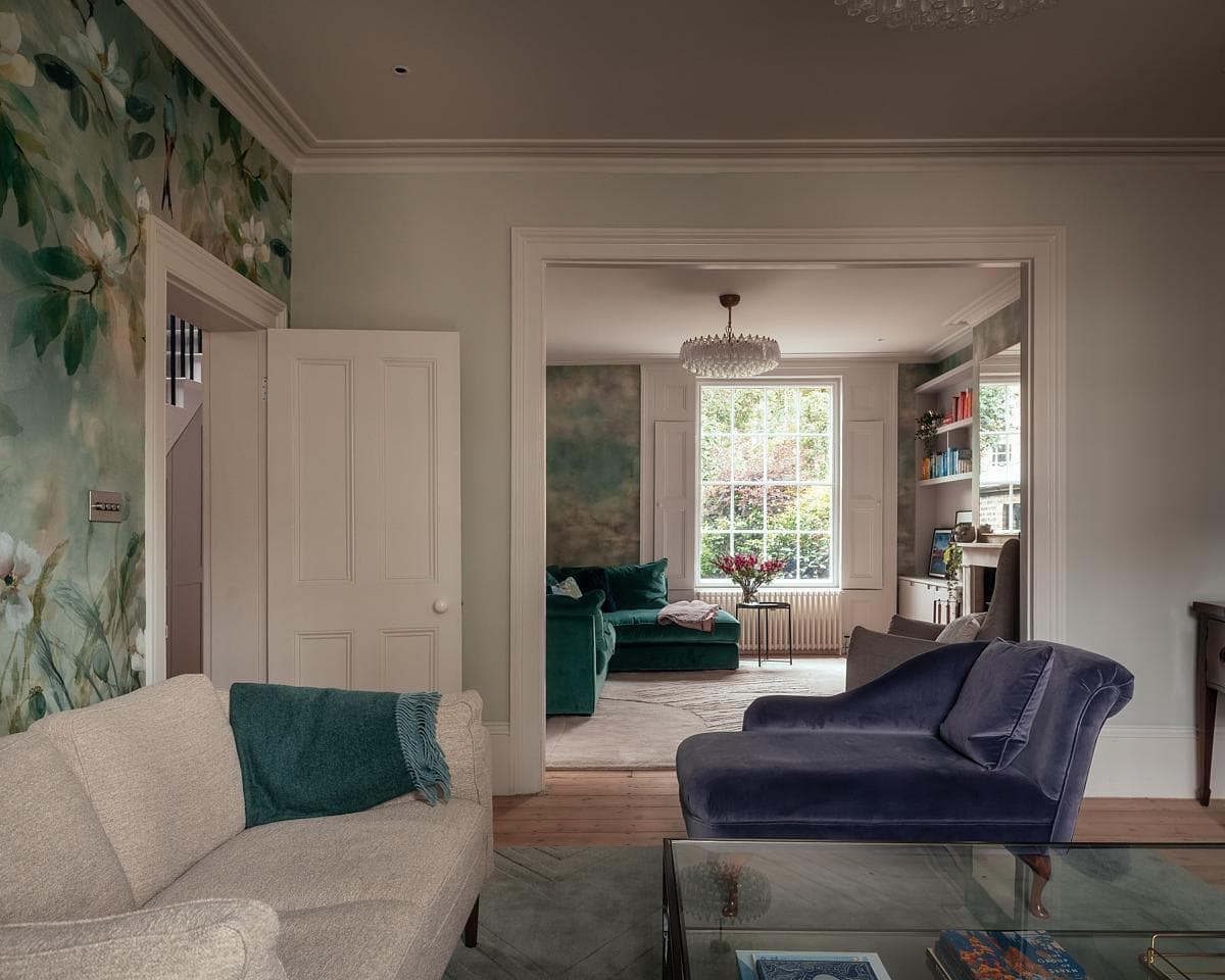 Stylish living room featuring floral accents, modern decor, and inviting light-coloured sofa.