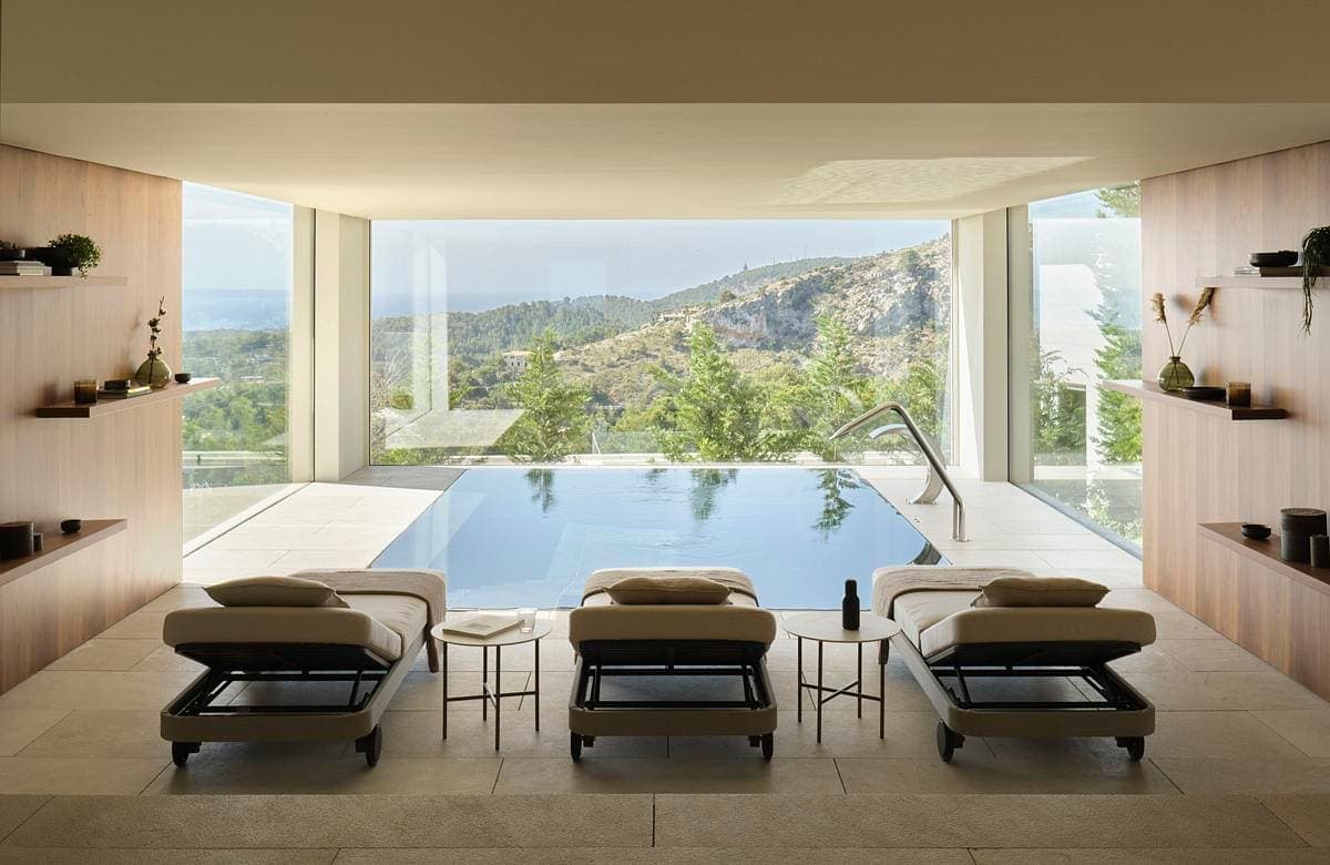Modern luxury interior featuring an infinity pool and stunning landscape views.