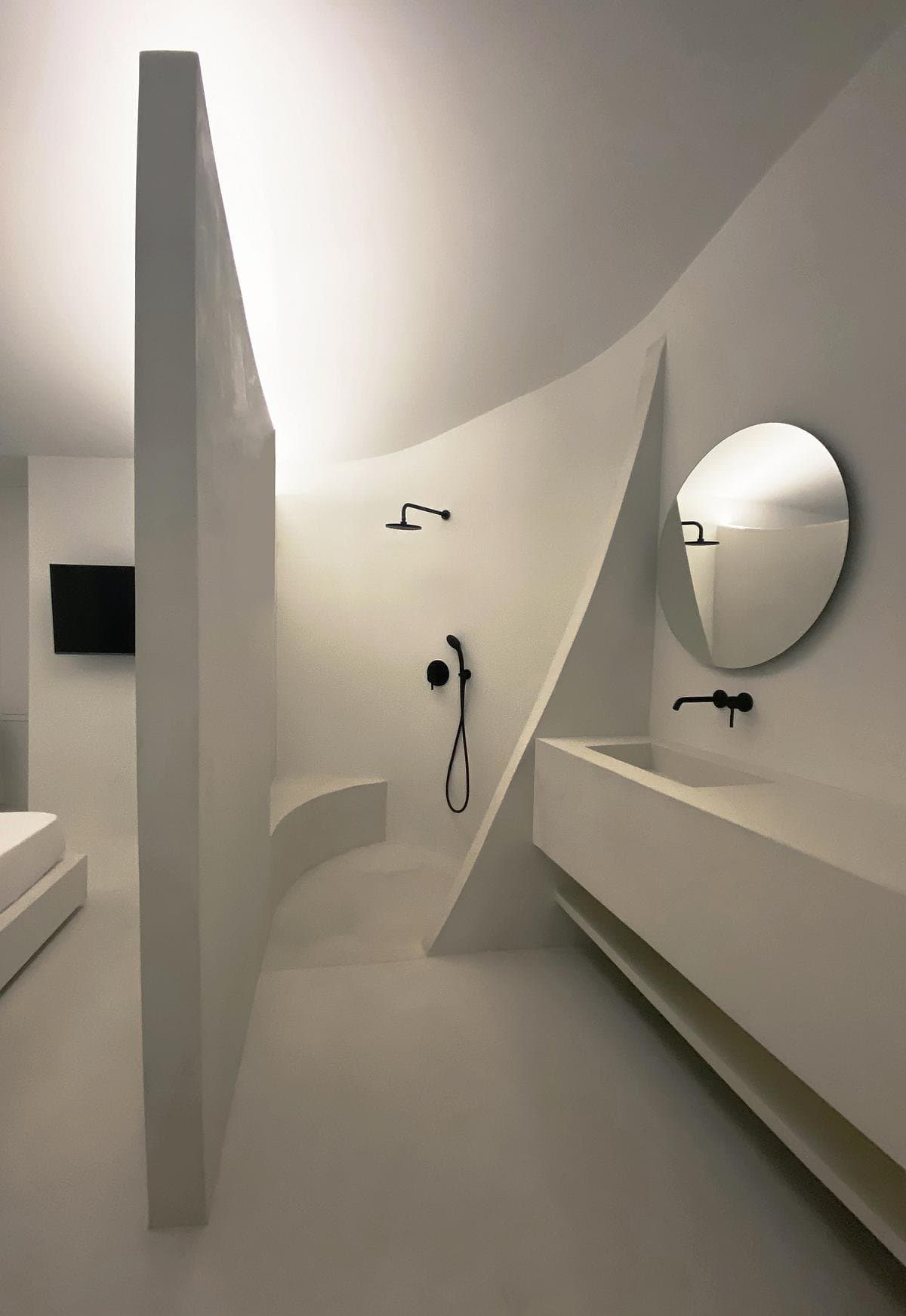 Contemporary minimalist bathroom featuring elegant curves, modern fixtures, and a serene atmosphere.
