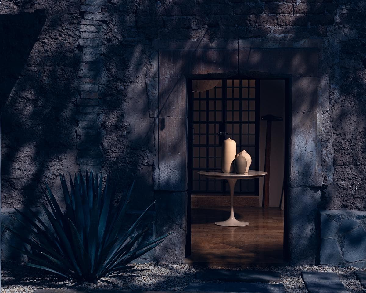 Tranquil minimalist doorway with candles and agave, inviting a serene atmosphere.