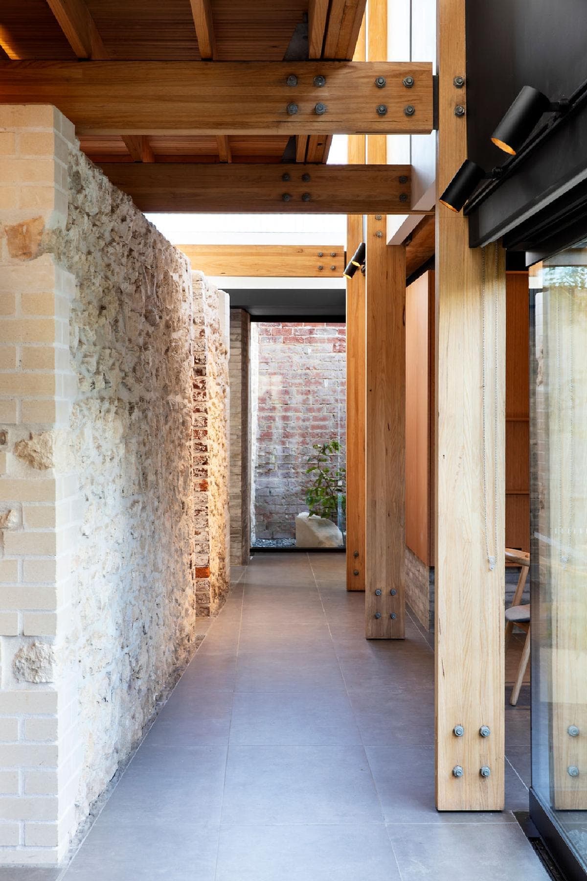 Stylish modern corridor featuring natural materials and abundant natural light.