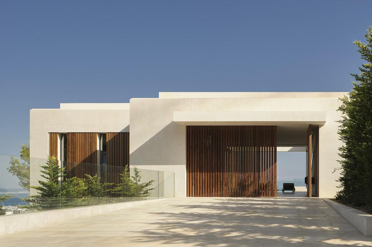 Contemporary home design seamlessly blending with nature and showcasing natural light and elegant materials.