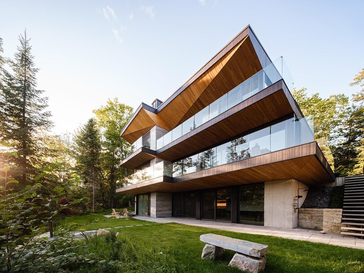 Contemporary architecture harmonising with nature, featuring glass, wood, and stunning landscaping.