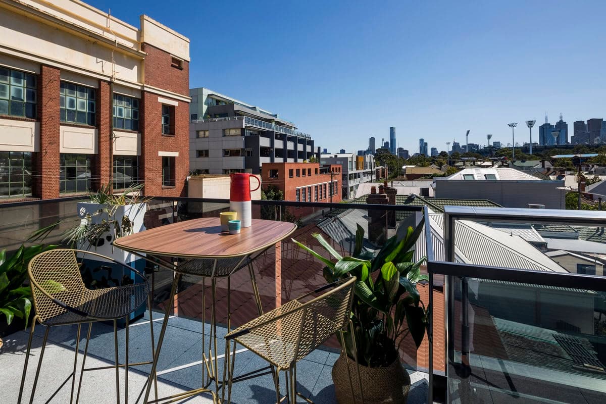Stylish urban balcony with elegant furniture and vibrant city views. Ideal for relaxation.