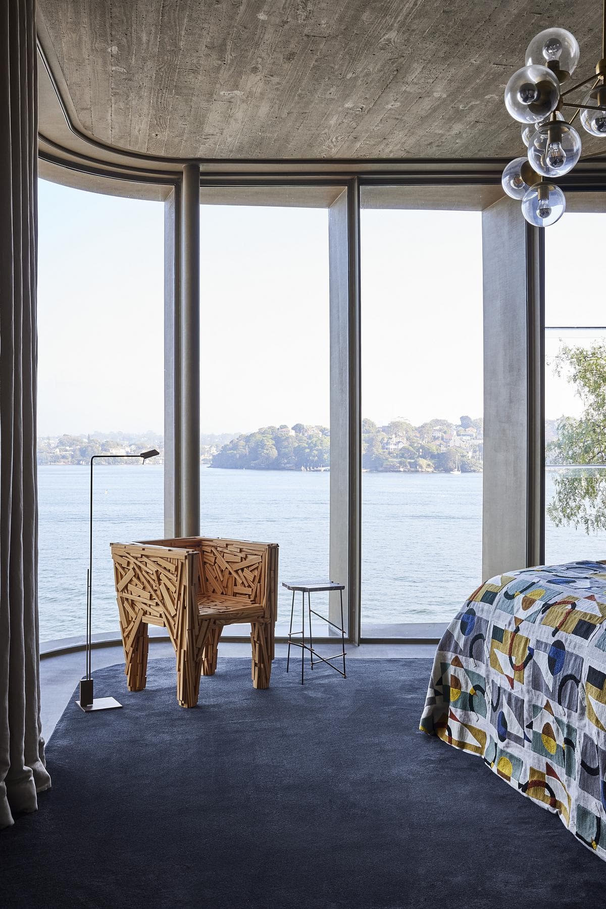 Contemporary bedroom with stunning waterfront views and elegant design features.
