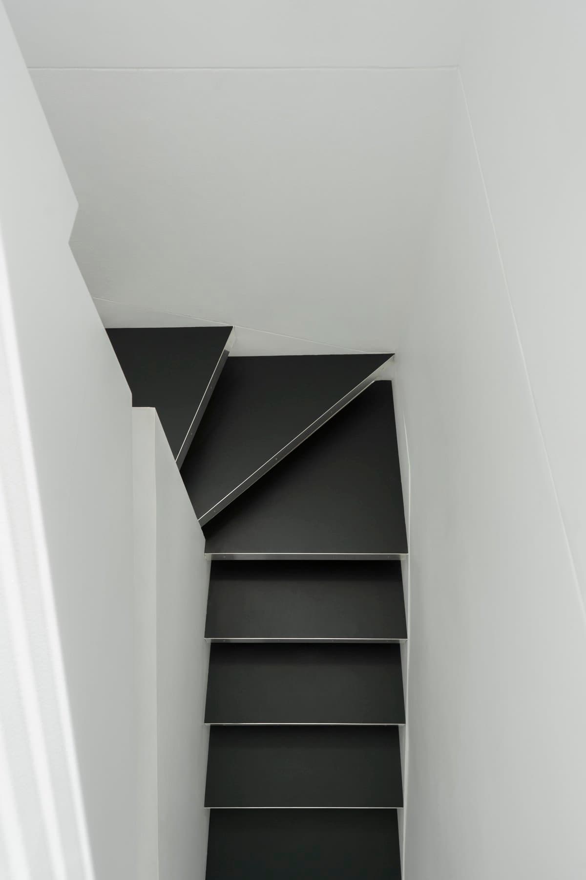 Minimalist black and white staircase with geometric design and clean lines.