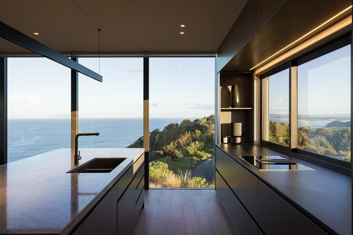 Modern coastal kitchen featuring ocean views and ample natural light for a serene atmosphere.