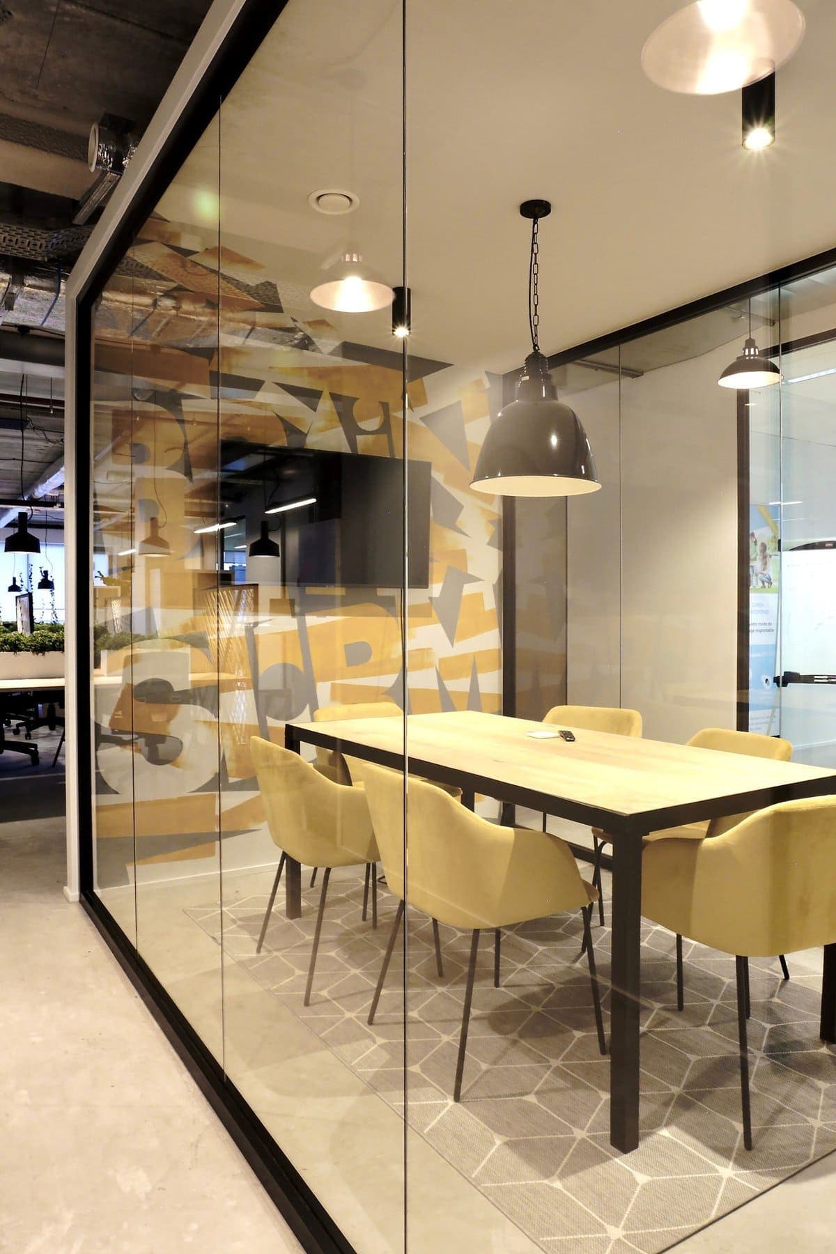 Modern conference room with glass walls, industrial design, and light wood furnishings - HIVE5.