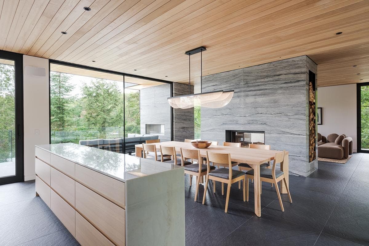 Stylish modern dining area with natural elements and seamless indoor-outdoor connection.