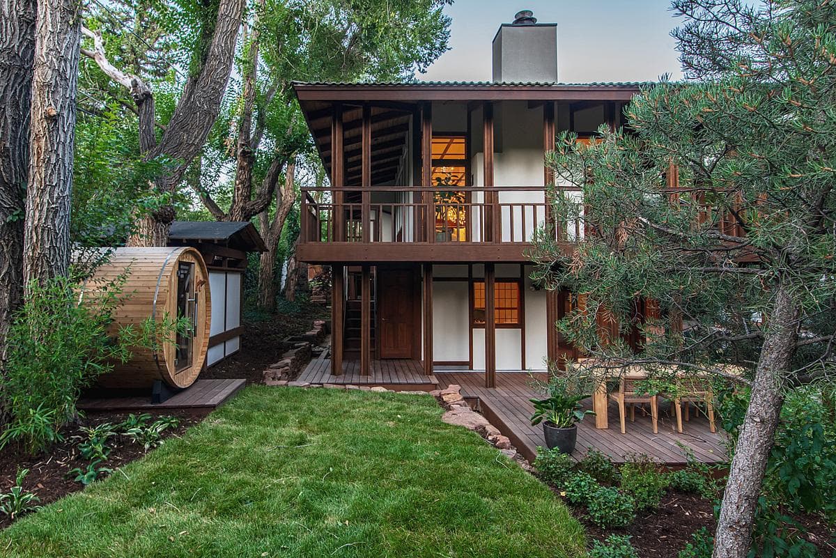 Contemporary wooden home surrounded by lush greenery, offering a tranquil nature retreat.