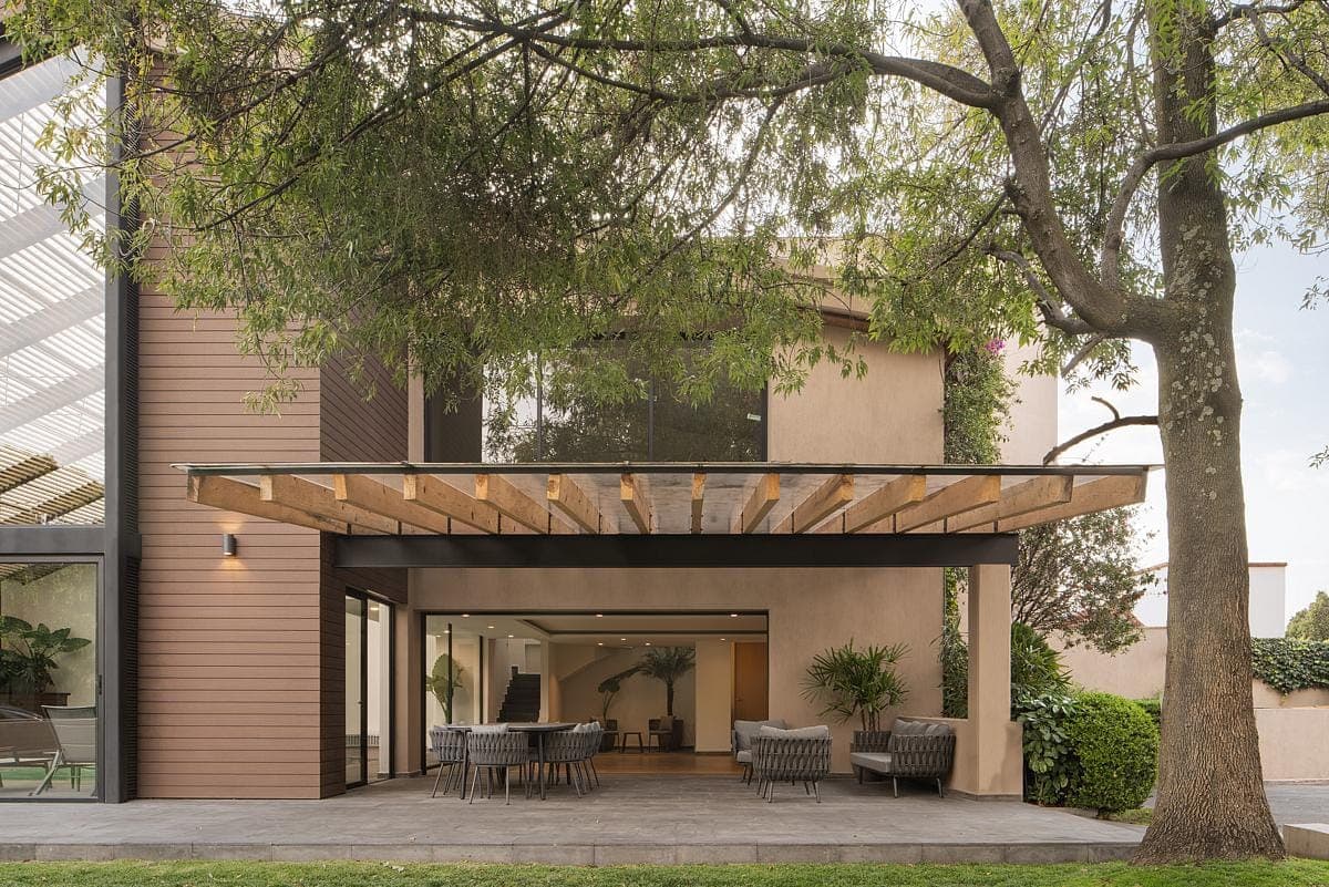 Modern home blending indoor and outdoor spaces with stylish patio and contemporary design elements.