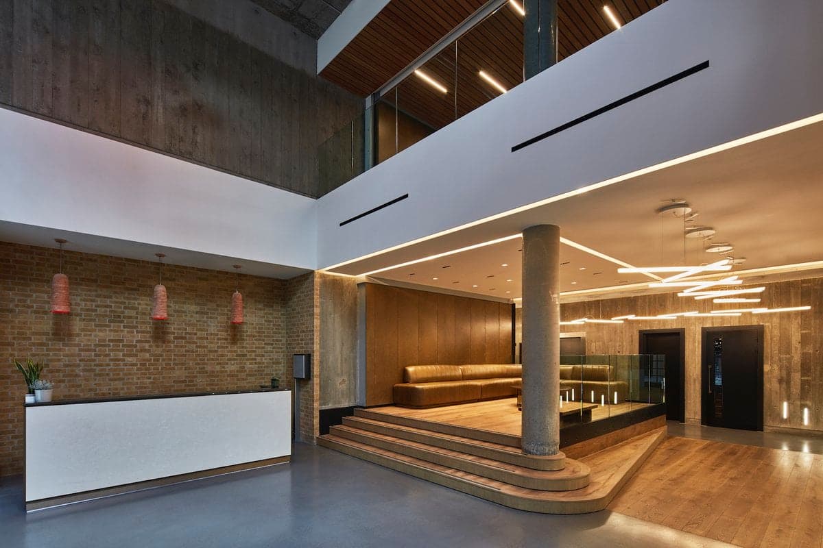 Entrance interior with exposed brick, timber finishes and pendant lights.