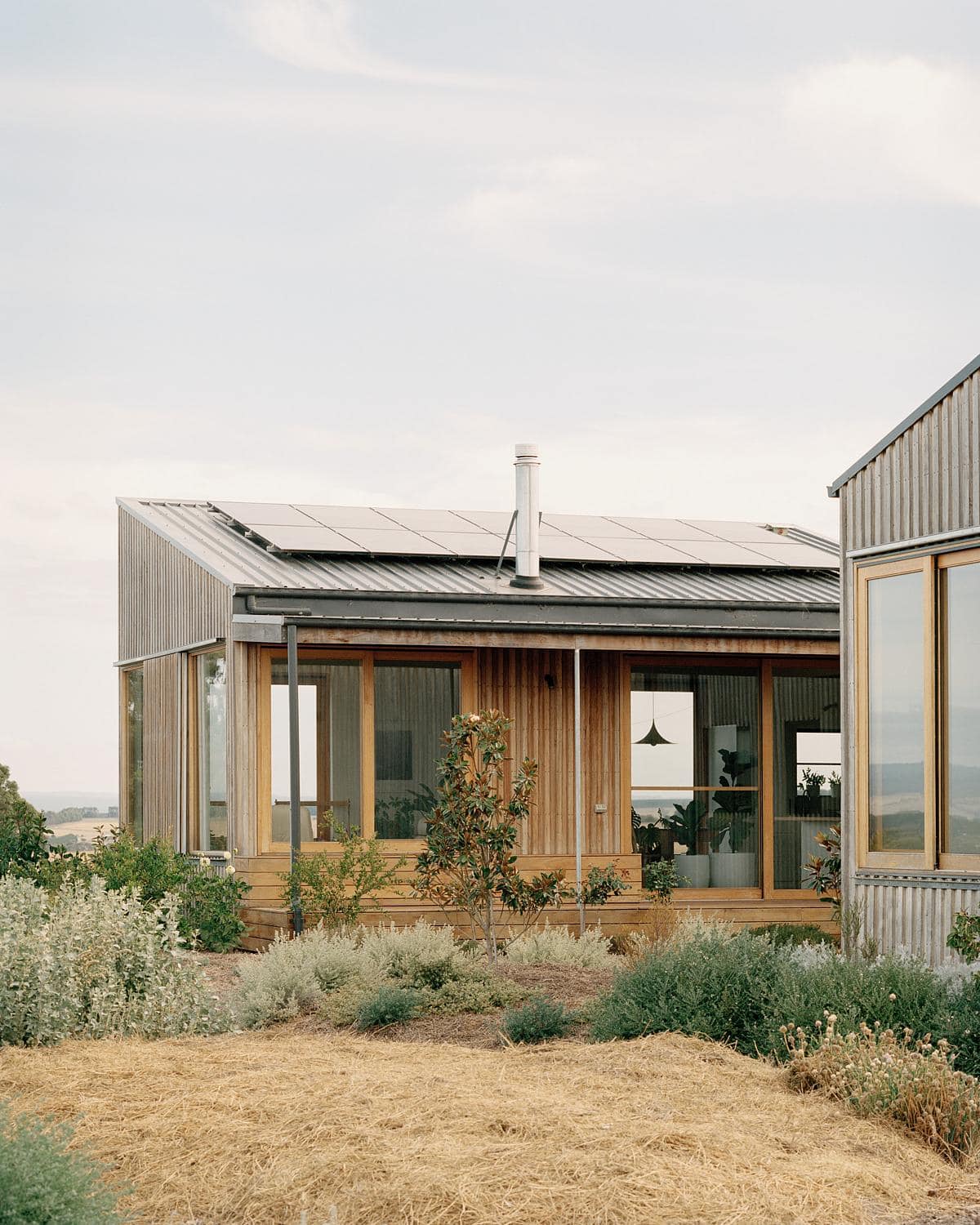 Eco-friendly modern home surrounded by tranquil landscaping and a harmonious natural environment.