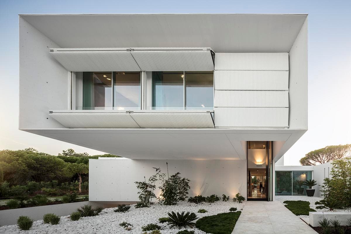 Contemporary cantilevered house design showcasing sleek lines and abundant natural light.