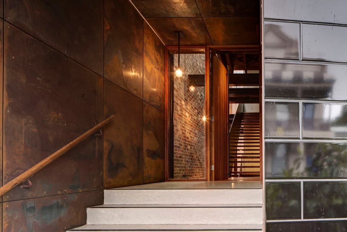 Contemporary industrial entrance featuring warm textures and minimalist design elements.