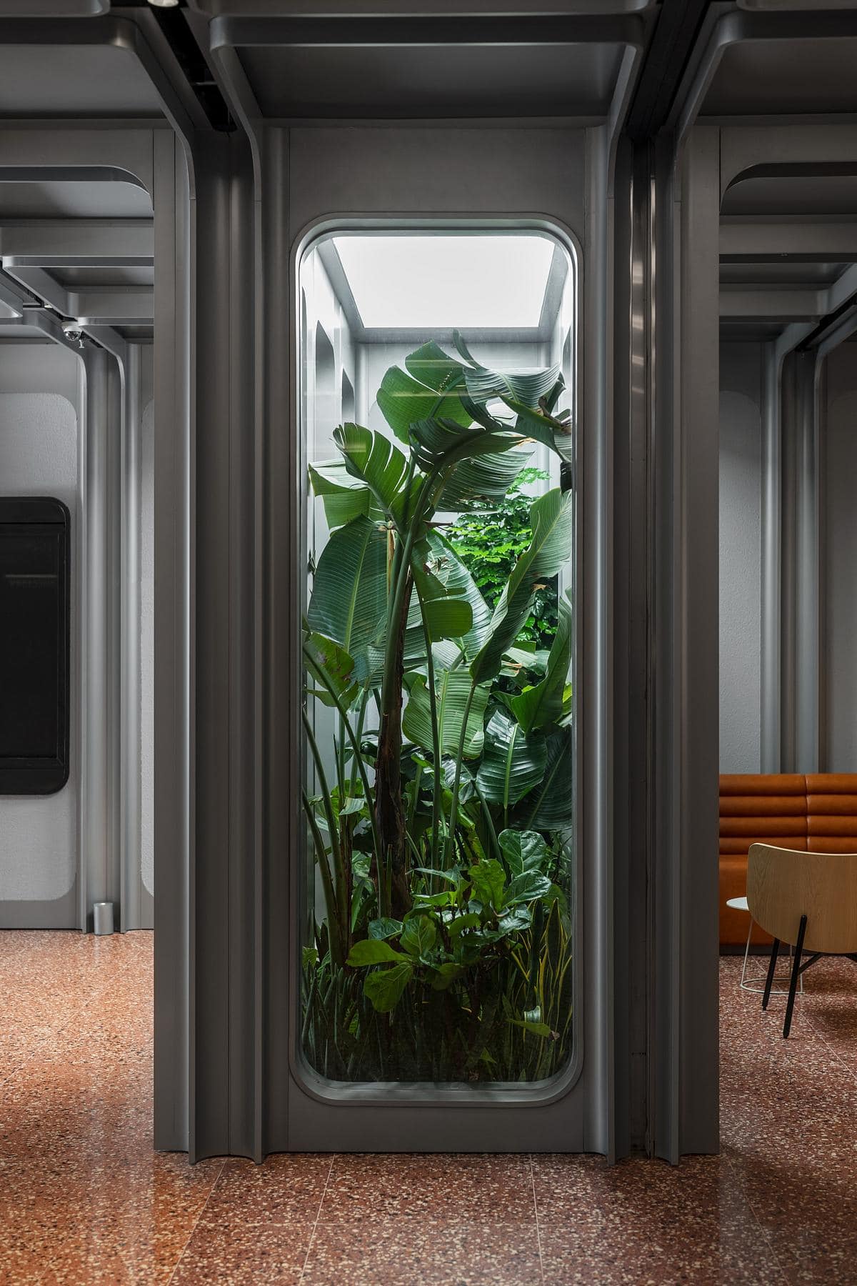 Modern interior featuring lush greenery and elegant design, creating a serene, inviting atmosphere.