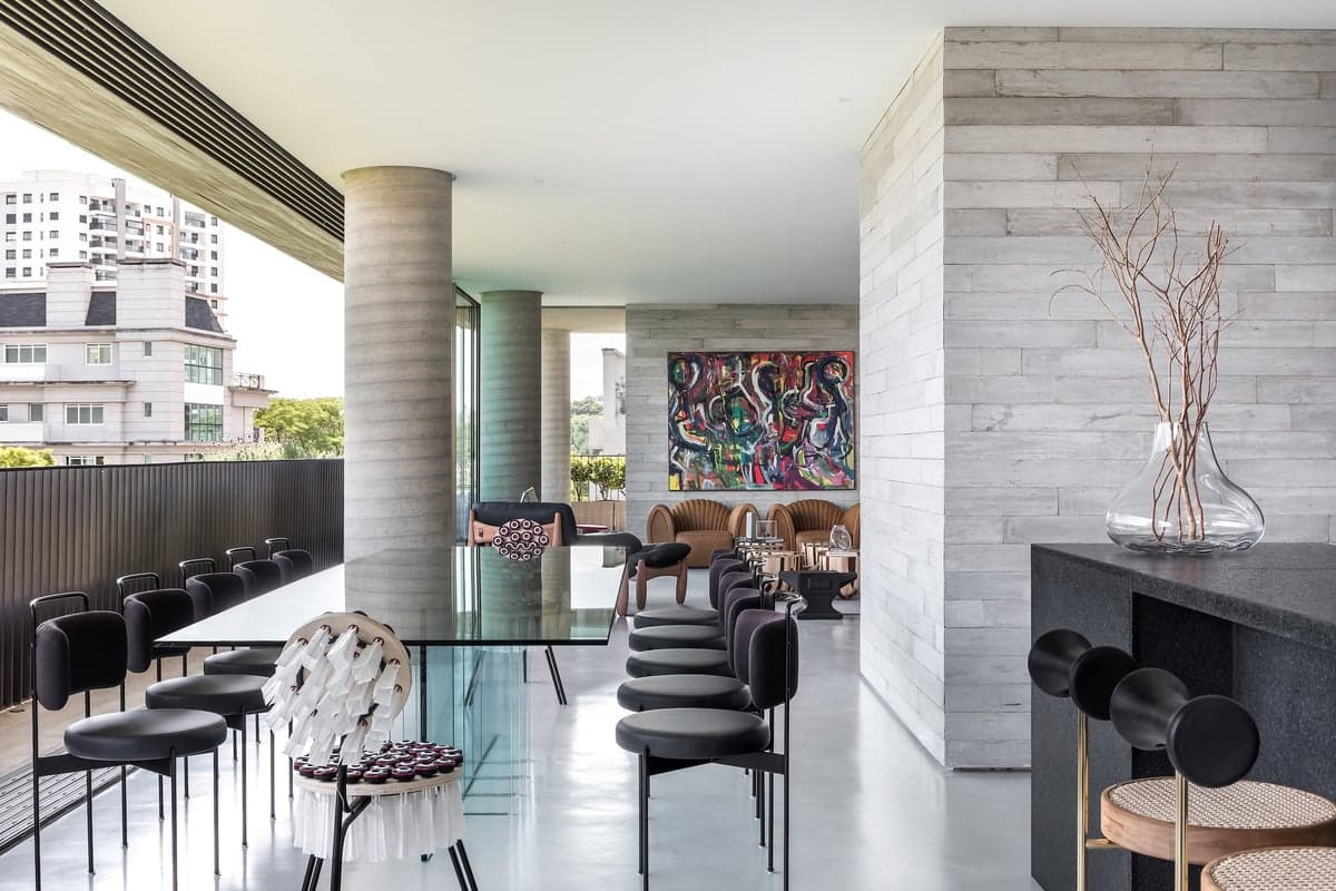 Sophisticated modern interior with abstract art, bright natural light, and elegant dining area.