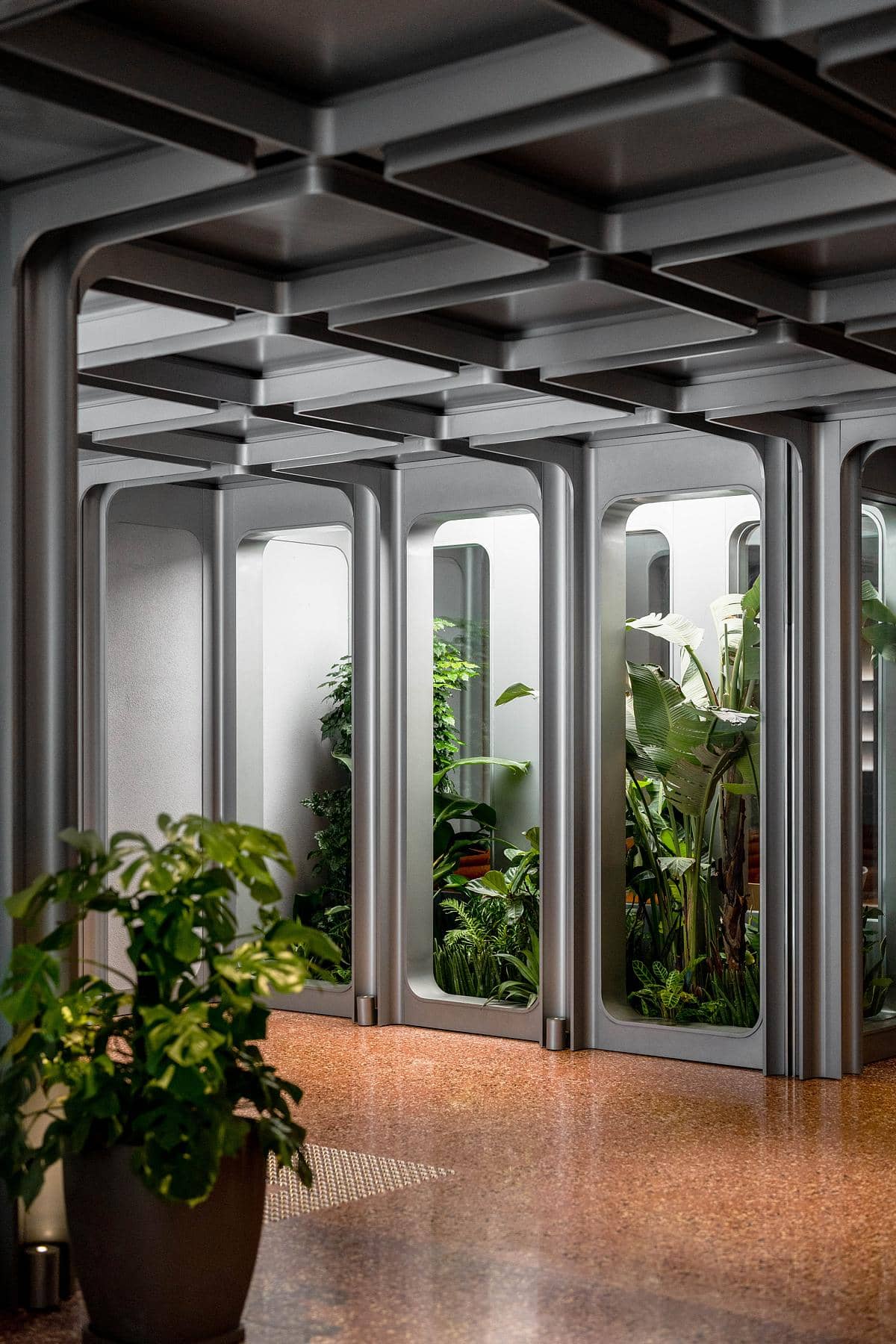 Contemporary interior blending metallic design with lush greenery for a harmonious urban atmosphere.