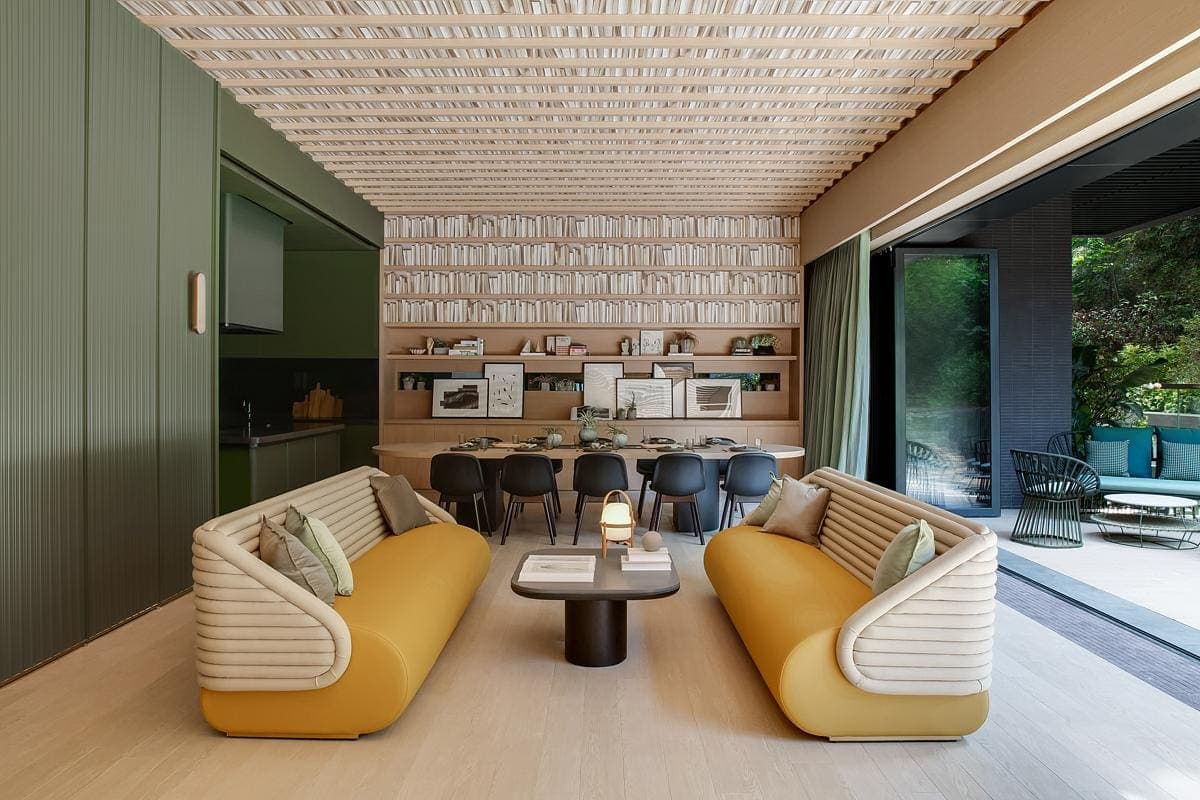Modern lounge with stylish sofas, elegant dining area, and abundant natural light.