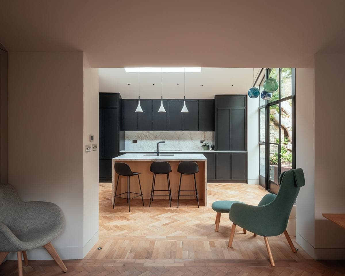 Contemporary kitchen and dining area by Neil Dusheiko Architects, showcasing stylish design and natural light.