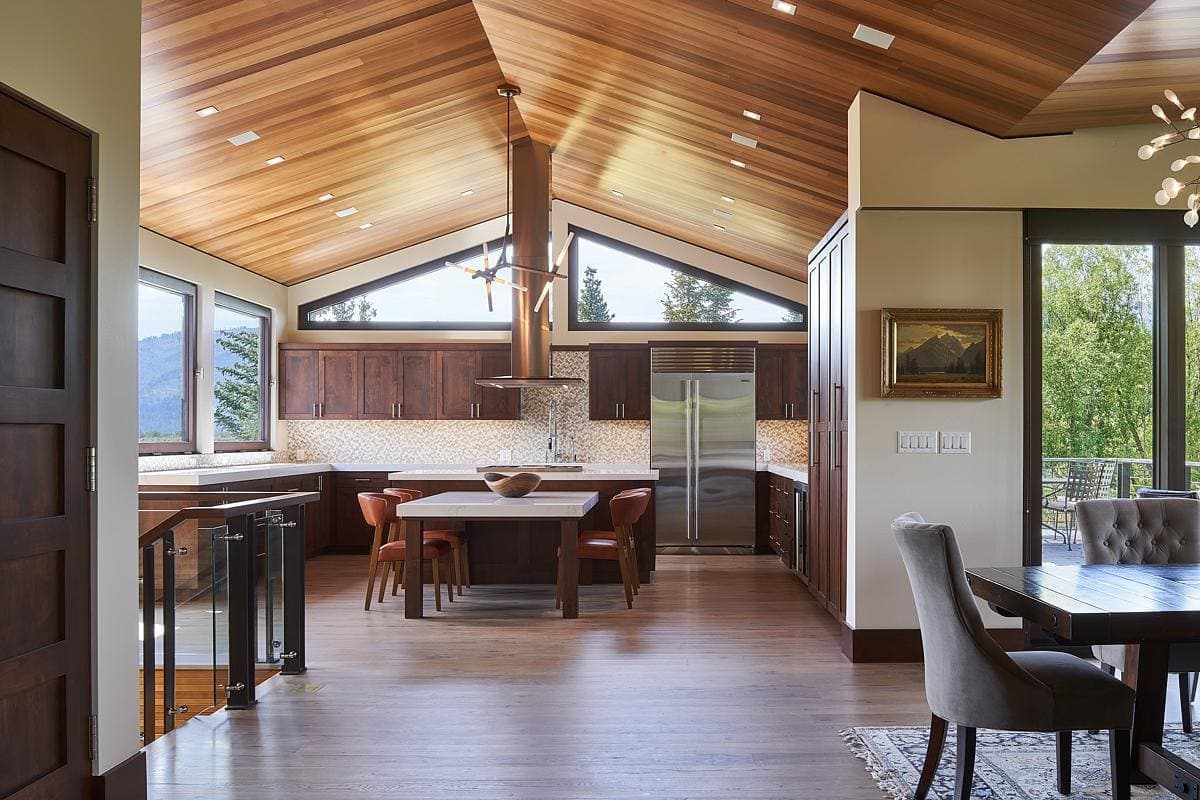 Stylish modern kitchen with inviting dining space and natural light, perfect for entertaining.