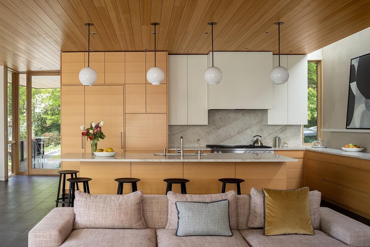Stylish modern kitchen and living area with warm wood accents and elegant design features.
