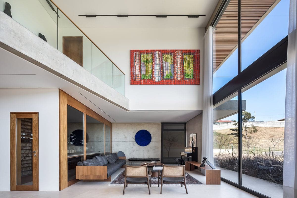 Modern living room with floor-to-ceiling windows and minimalist decor.