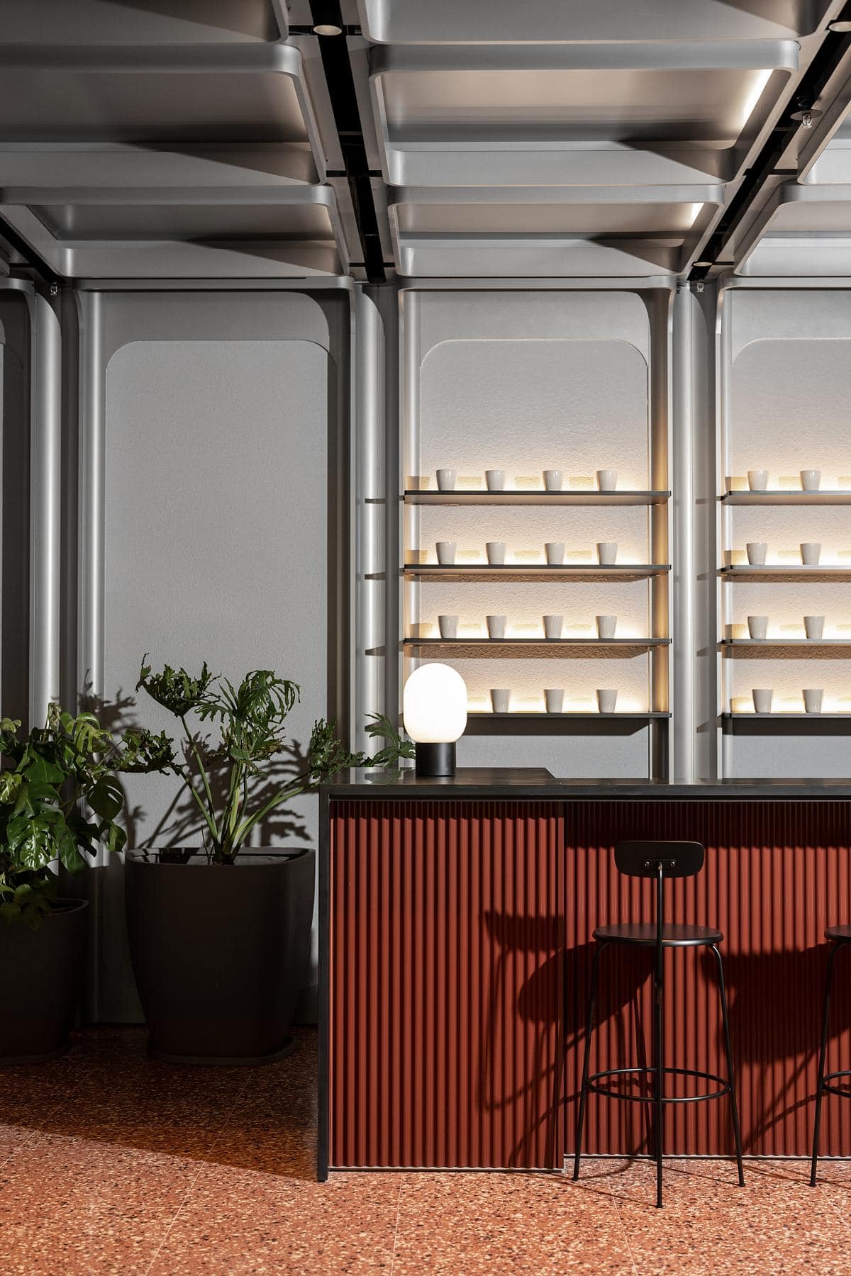 Contemporary minimalist bar interior with wooden textures, sleek design, and vibrant greenery.