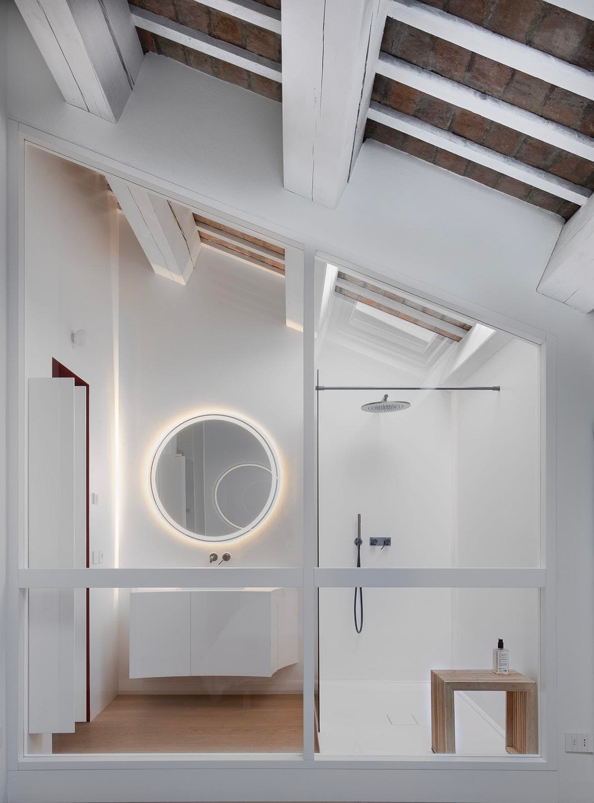 Modern minimalist bathroom with wooden beams, sleek vanity, and inviting natural light.