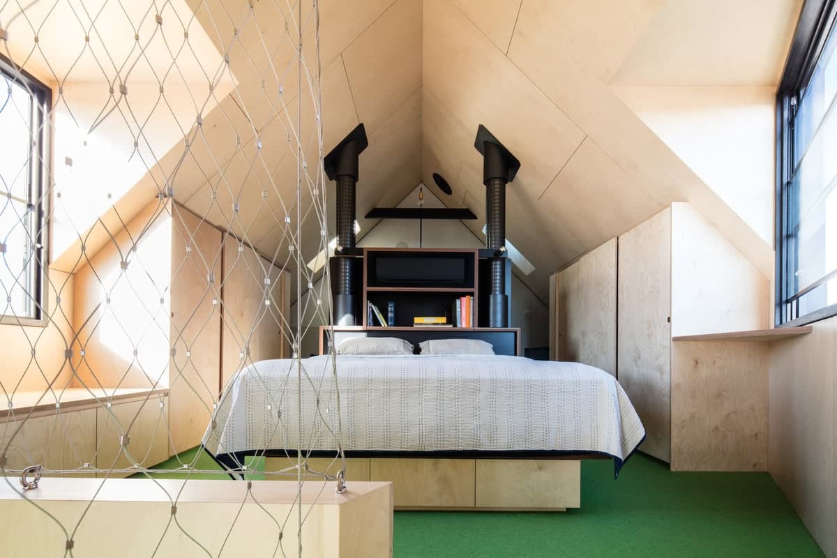 Stylish minimalist bedroom with unique architecture and natural light features.