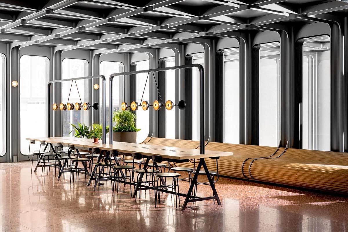 Stylish modern minimalist dining room with wooden table, large windows, and inviting pendant lights.
