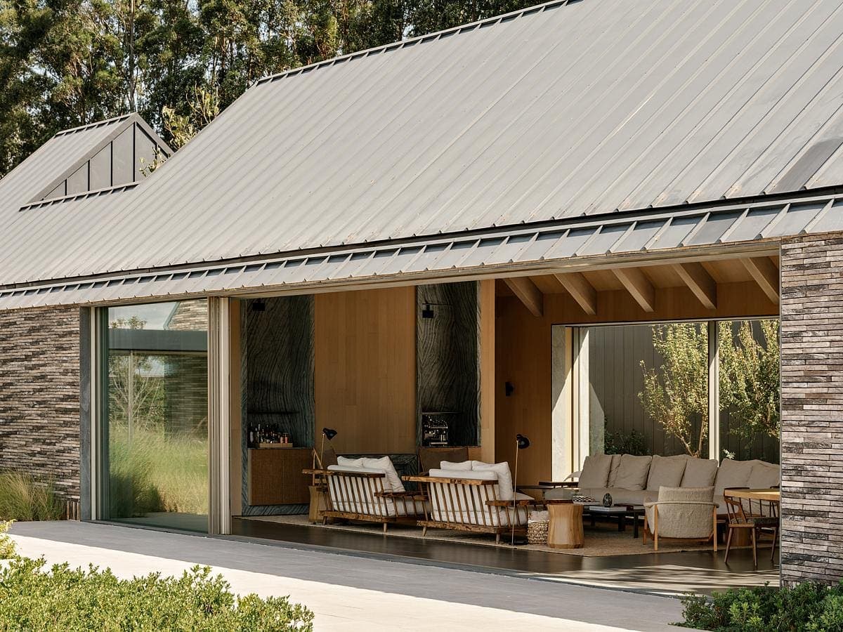 Modern minimalist home with inviting lounge and seamless indoor-outdoor connection to nature.