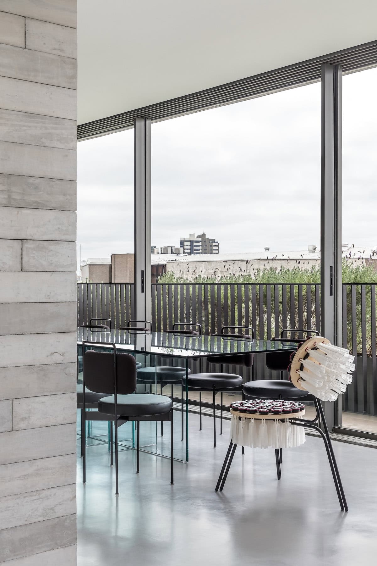 Elegant modern minimalist interior with large windows, varied seating, and a serene colour palette.