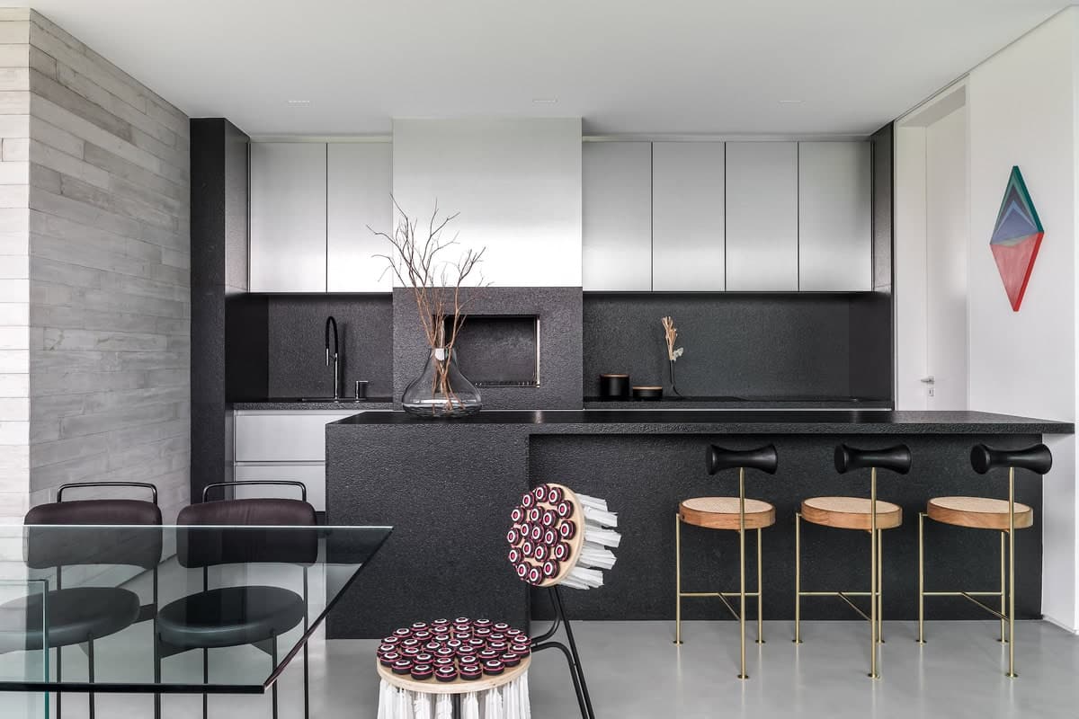 Sleek modern kitchen with minimalist design, elegant dining area, and striking geometric artwork.