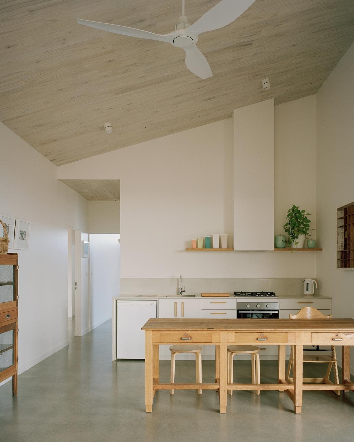 Spacious modern kitchen with natural wood accents and minimalist design for an inviting atmosphere.