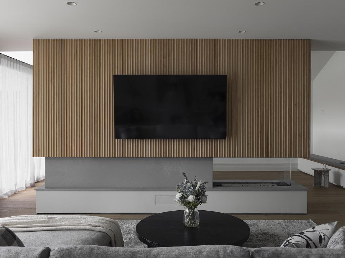 Contemporary minimalist living room featuring a wooden accent wall and stylish decor.