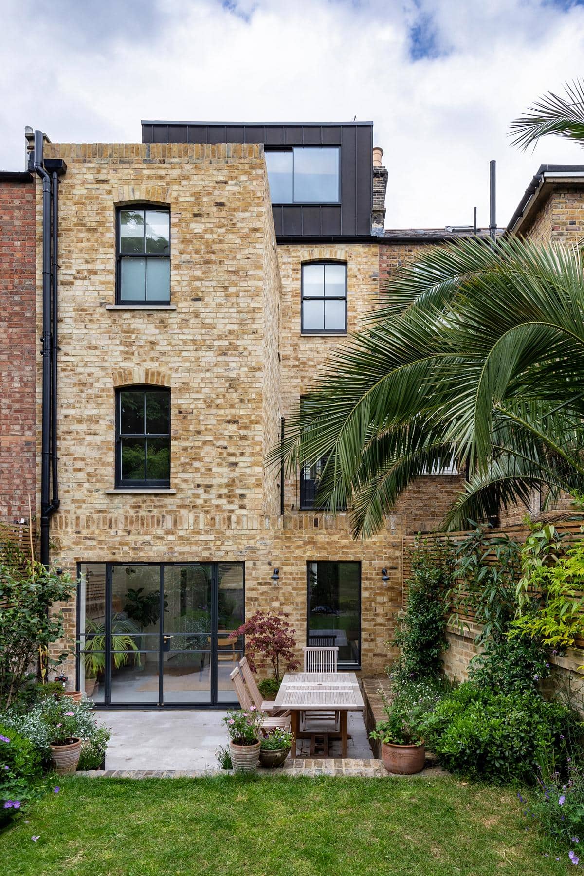 Stylish contemporary home featuring a lovely garden and inviting outdoor patio.