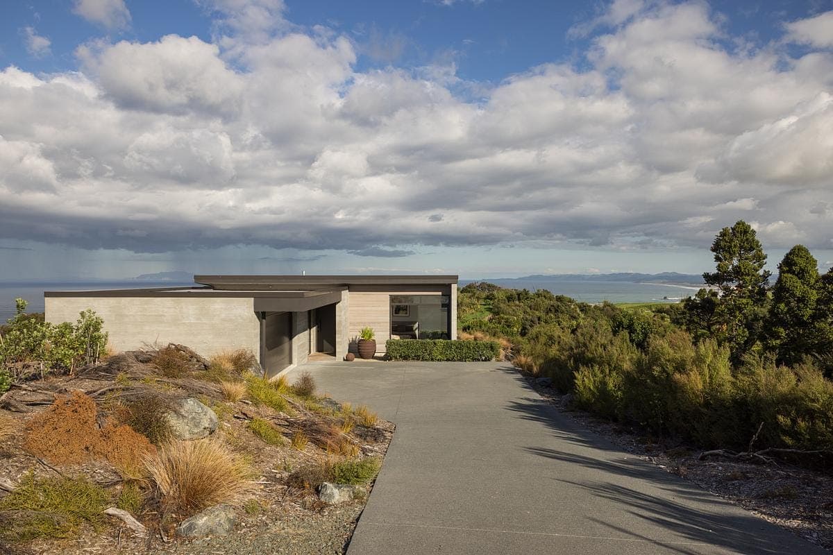 Modern single-storey house blending seamlessly with nature in a serene, scenic location.