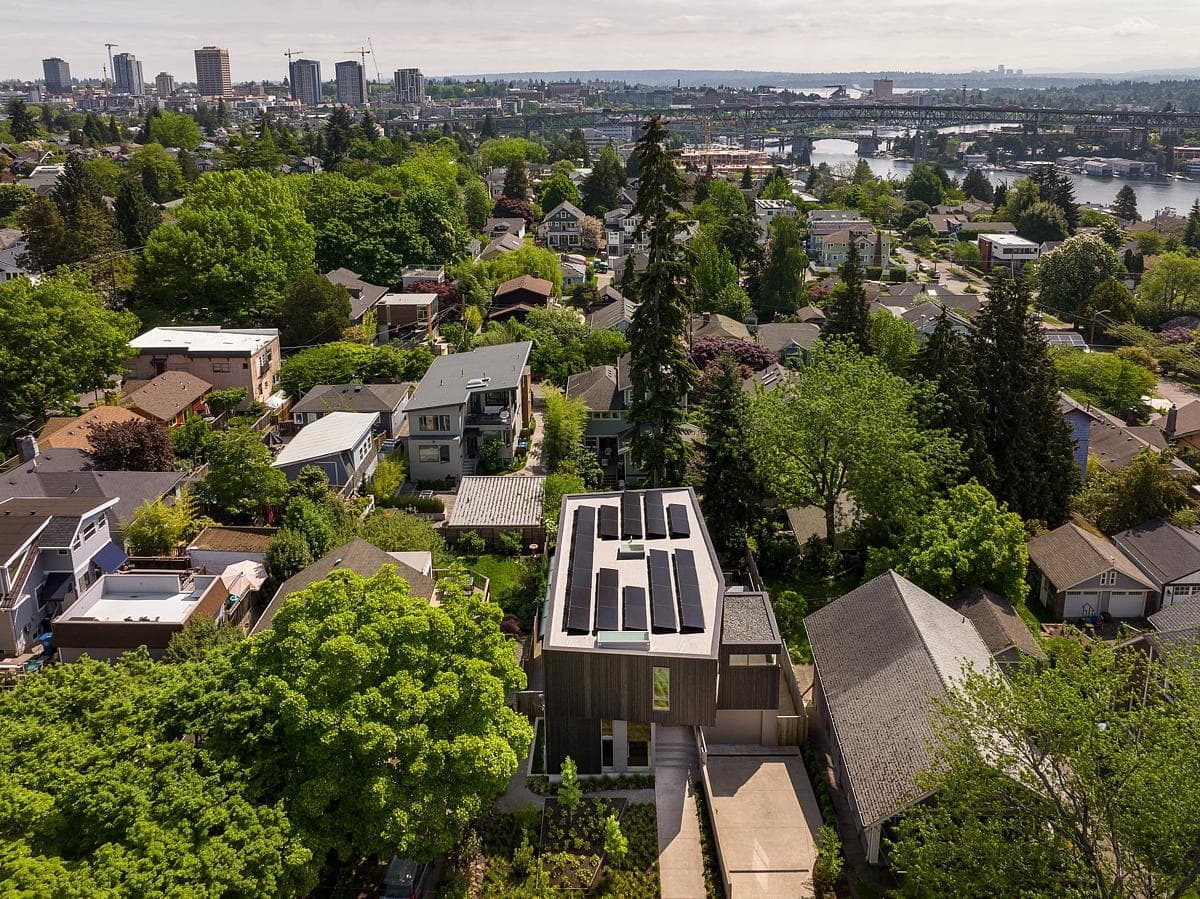 Modern suburban neighbourhood blending contemporary architecture with traditional homes and lush greenery.